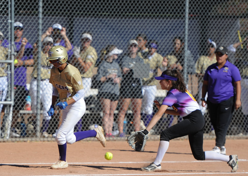 Holy Family's Sierra Nanez, left, attempts to score on an infield grounder fielded by Denver North's Sophie Scholl on Oct. 16 at Broomfield Industrial Park. The Tigers reached the CHSAA 4A state tournament by beating both North (15-0) and Berthoud (10-0).
